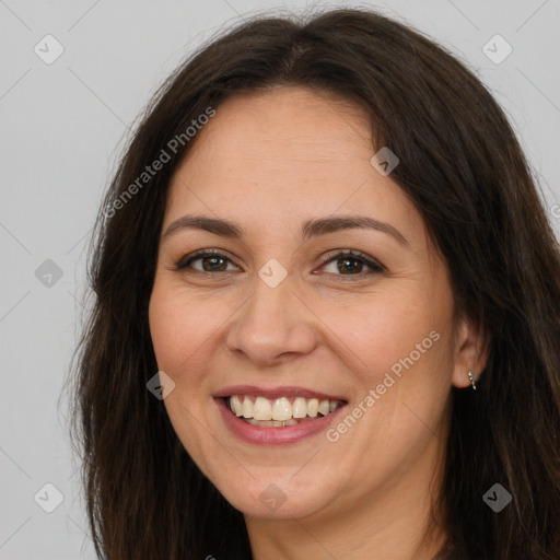 Joyful white adult female with long  brown hair and brown eyes