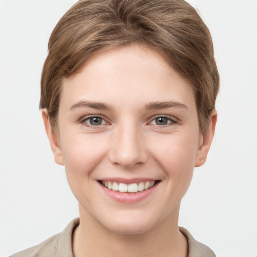 Joyful white young-adult female with short  brown hair and grey eyes