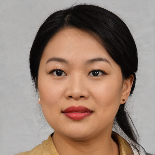 Joyful asian young-adult female with medium  black hair and brown eyes
