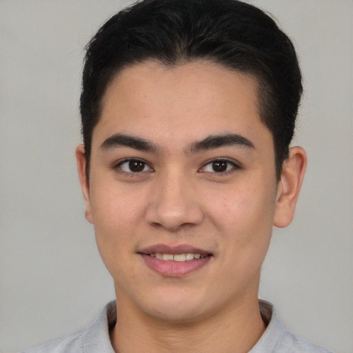 Joyful latino young-adult male with short  brown hair and brown eyes