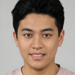 Joyful asian young-adult male with short  black hair and brown eyes