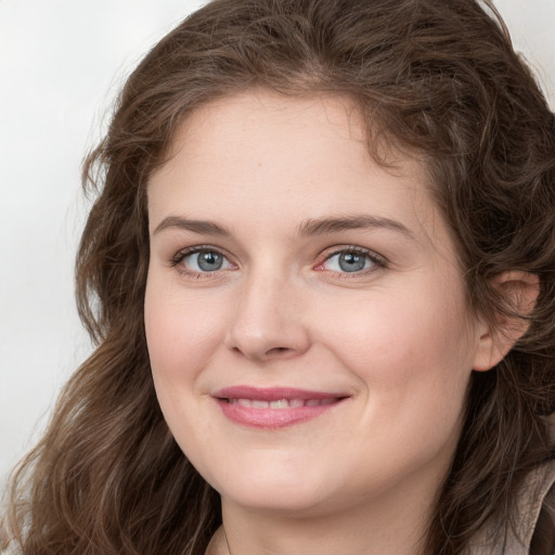 Joyful white young-adult female with long  brown hair and green eyes