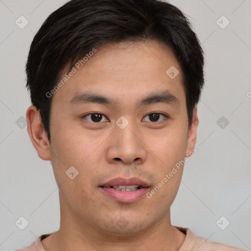 Joyful asian young-adult male with short  brown hair and brown eyes