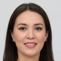 Joyful white young-adult female with long  brown hair and brown eyes