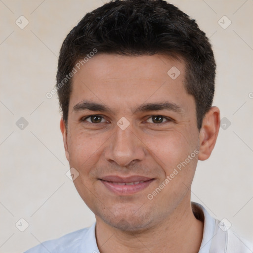 Joyful white young-adult male with short  black hair and brown eyes