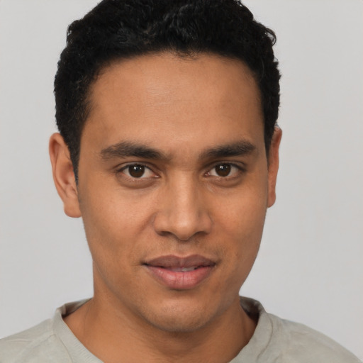 Joyful latino young-adult male with short  black hair and brown eyes
