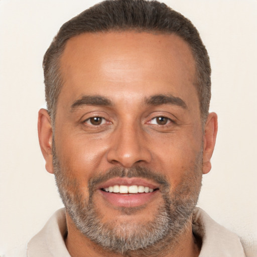 Joyful white adult male with short  brown hair and brown eyes