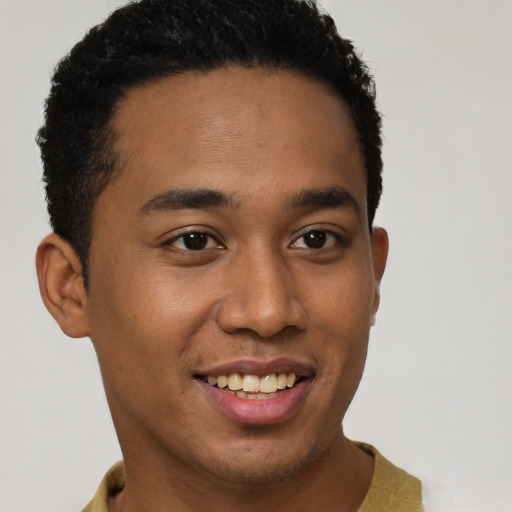 Joyful latino young-adult male with short  brown hair and brown eyes