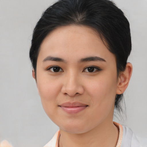 Joyful asian young-adult female with medium  brown hair and brown eyes