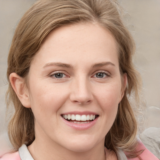 Joyful white young-adult female with medium  brown hair and blue eyes