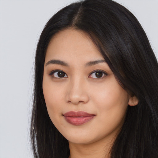Joyful asian young-adult female with long  black hair and brown eyes