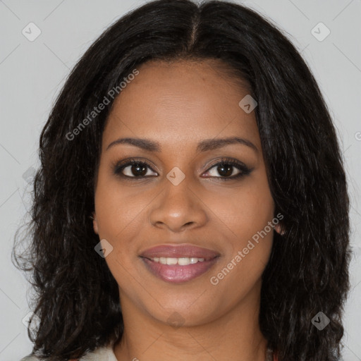 Joyful black young-adult female with long  brown hair and brown eyes