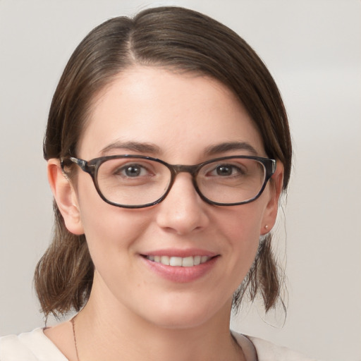 Joyful white young-adult female with medium  brown hair and grey eyes