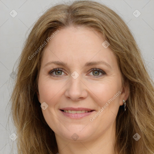 Joyful white adult female with long  brown hair and green eyes