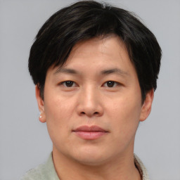 Joyful asian young-adult male with short  brown hair and brown eyes