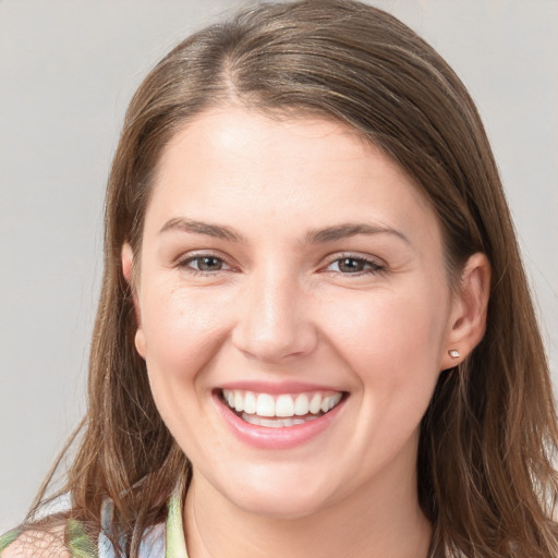 Joyful white young-adult female with long  brown hair and grey eyes