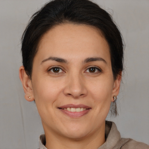 Joyful white young-adult female with medium  brown hair and brown eyes