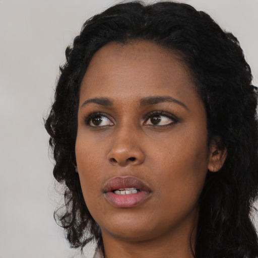 Neutral black young-adult female with long  black hair and brown eyes