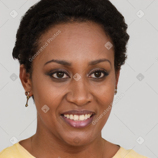 Joyful black young-adult female with short  brown hair and brown eyes