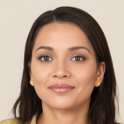 Joyful latino young-adult female with long  brown hair and brown eyes