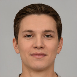 Joyful white young-adult male with short  brown hair and grey eyes