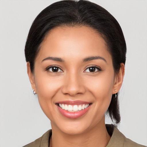 Joyful latino young-adult female with medium  brown hair and brown eyes