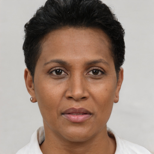 Joyful black adult female with short  brown hair and brown eyes