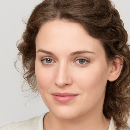 Joyful white young-adult female with medium  brown hair and green eyes