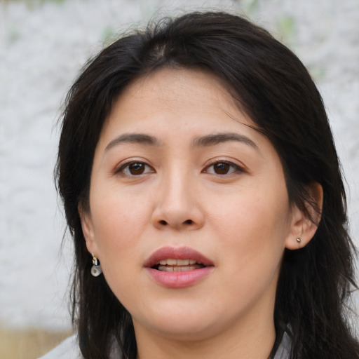 Joyful asian young-adult female with medium  brown hair and brown eyes