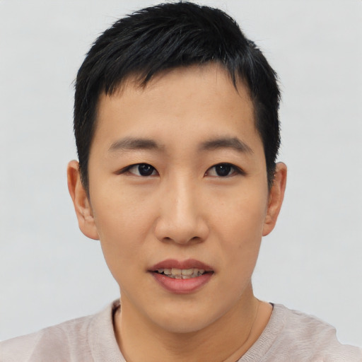 Joyful asian young-adult male with short  black hair and brown eyes