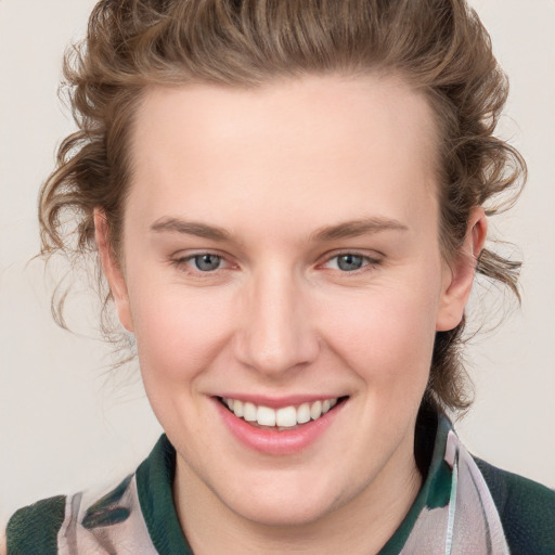 Joyful white young-adult female with medium  brown hair and blue eyes