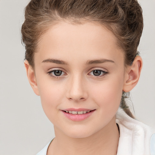 Joyful white child female with short  brown hair and brown eyes