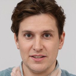 Joyful white adult male with short  brown hair and grey eyes