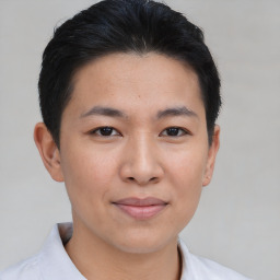 Joyful asian young-adult male with short  black hair and brown eyes