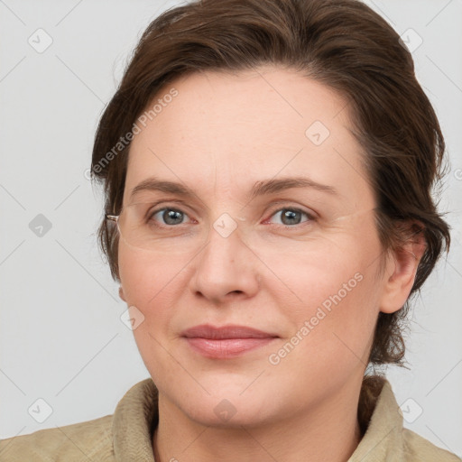 Joyful white adult female with medium  brown hair and grey eyes