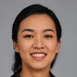 Joyful asian young-adult female with medium  black hair and brown eyes