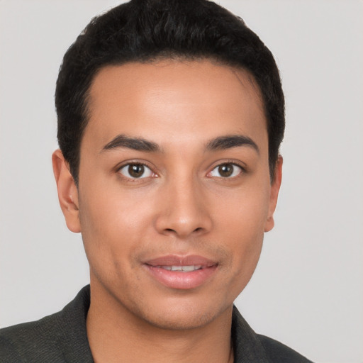 Joyful latino young-adult male with short  brown hair and brown eyes