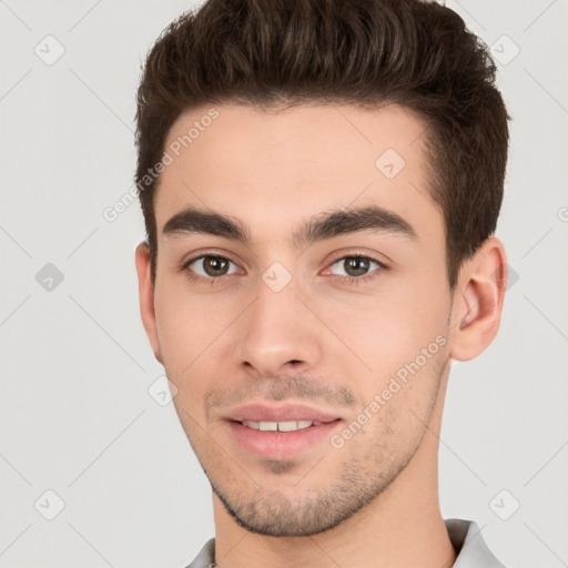 Joyful white young-adult male with short  brown hair and brown eyes