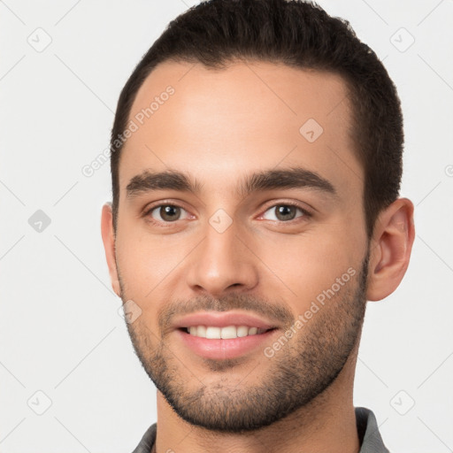 Joyful white young-adult male with short  brown hair and brown eyes