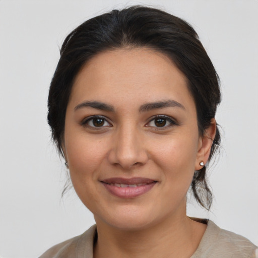 Joyful latino young-adult female with medium  brown hair and brown eyes