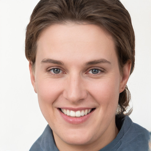 Joyful white young-adult female with short  brown hair and grey eyes