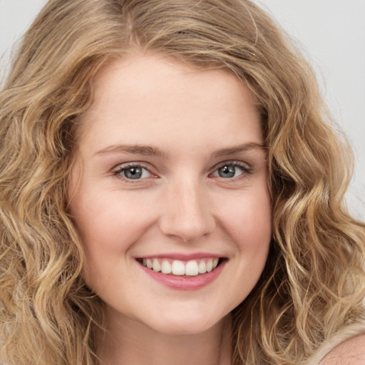 Joyful white young-adult female with long  brown hair and green eyes