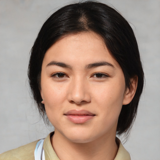 Joyful asian young-adult female with medium  black hair and brown eyes