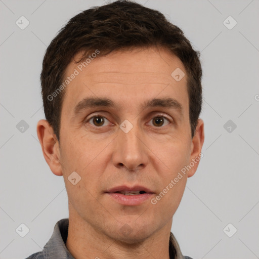 Joyful white adult male with short  brown hair and brown eyes