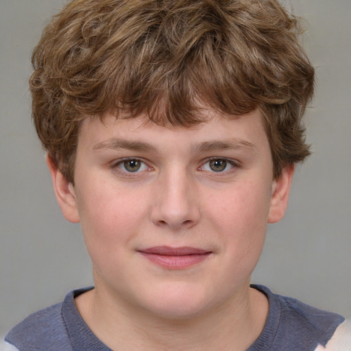 Joyful white child male with short  brown hair and blue eyes