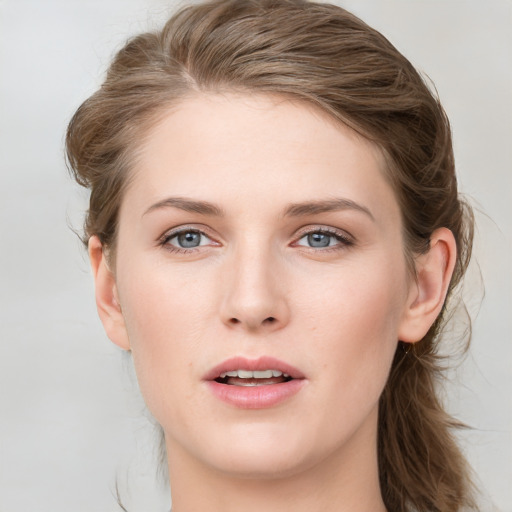 Joyful white young-adult female with long  brown hair and blue eyes