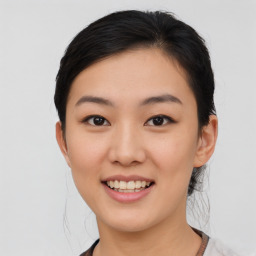 Joyful asian young-adult female with medium  black hair and brown eyes