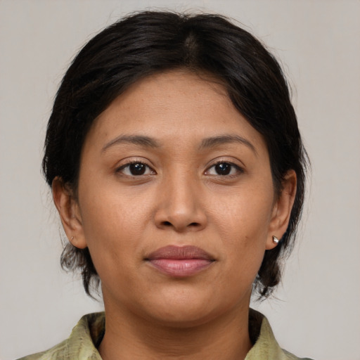 Joyful asian young-adult female with medium  brown hair and brown eyes