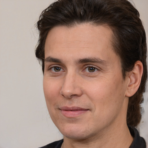 Joyful white adult male with medium  brown hair and brown eyes