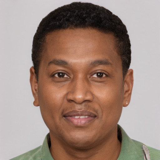 Joyful latino young-adult male with short  brown hair and brown eyes